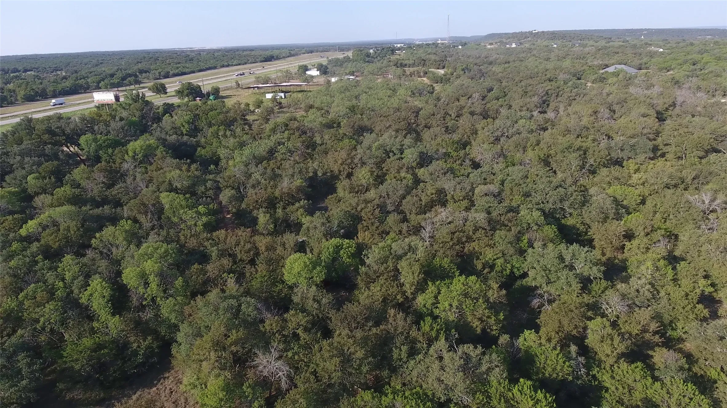 Aerial overview of property's location featuring a heavily wooded area
