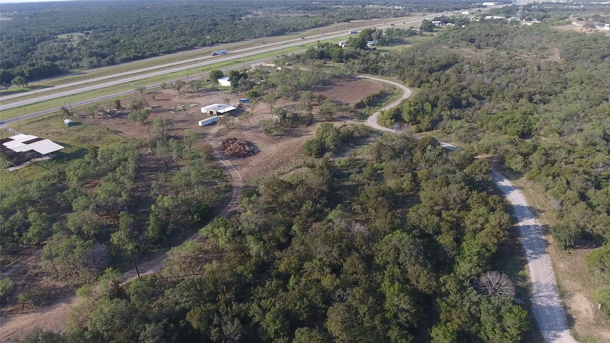 Aerial view of property's location featuring a forest