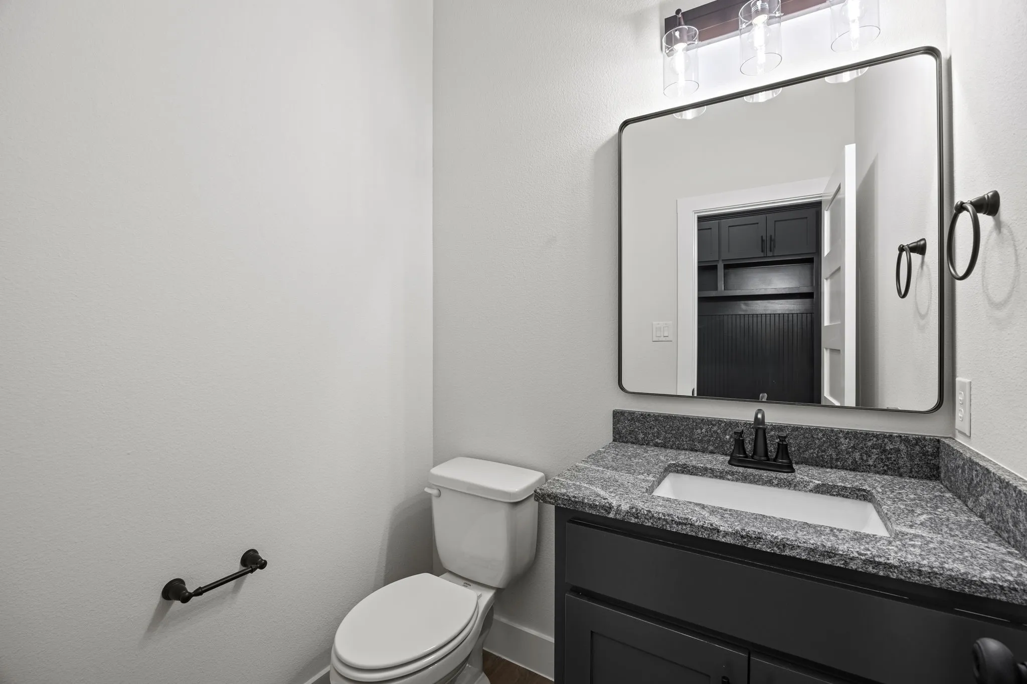 Bathroom featuring vanity and a textured wall