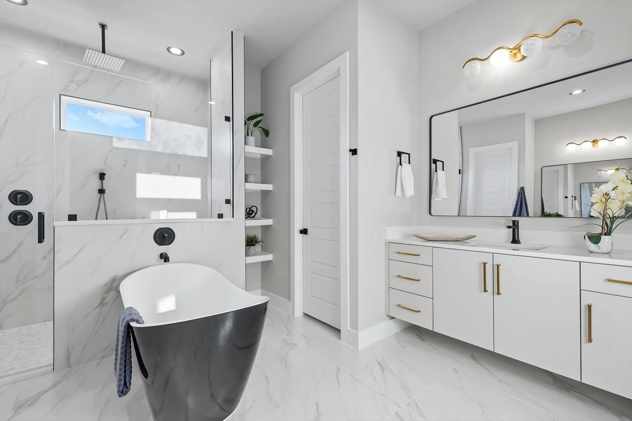 Full bath with a freestanding tub, vanity, a marble finish shower, light marble finish floors, and recessed lighting