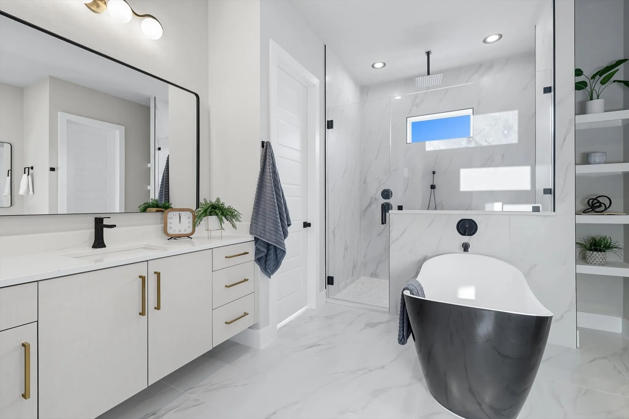 Full bathroom featuring vanity, a marble finish shower, a freestanding tub, light marble finish flooring, and recessed lighting