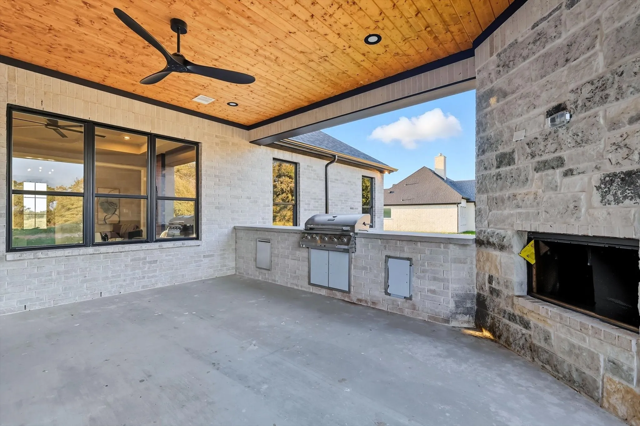 View of patio featuring an outdoor kitchen and ceiling fan