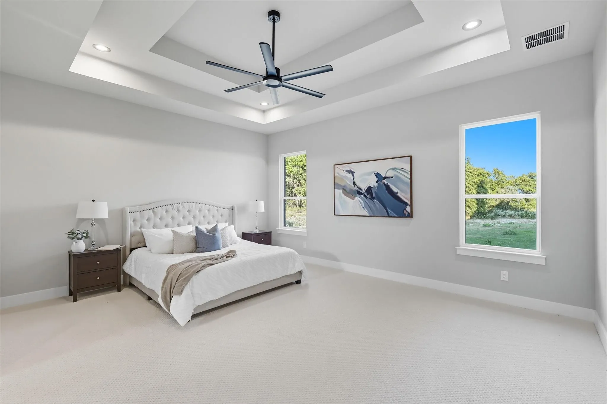 Bedroom featuring carpet flooring, a tray ceiling, a ceiling fan, and recessed lighting