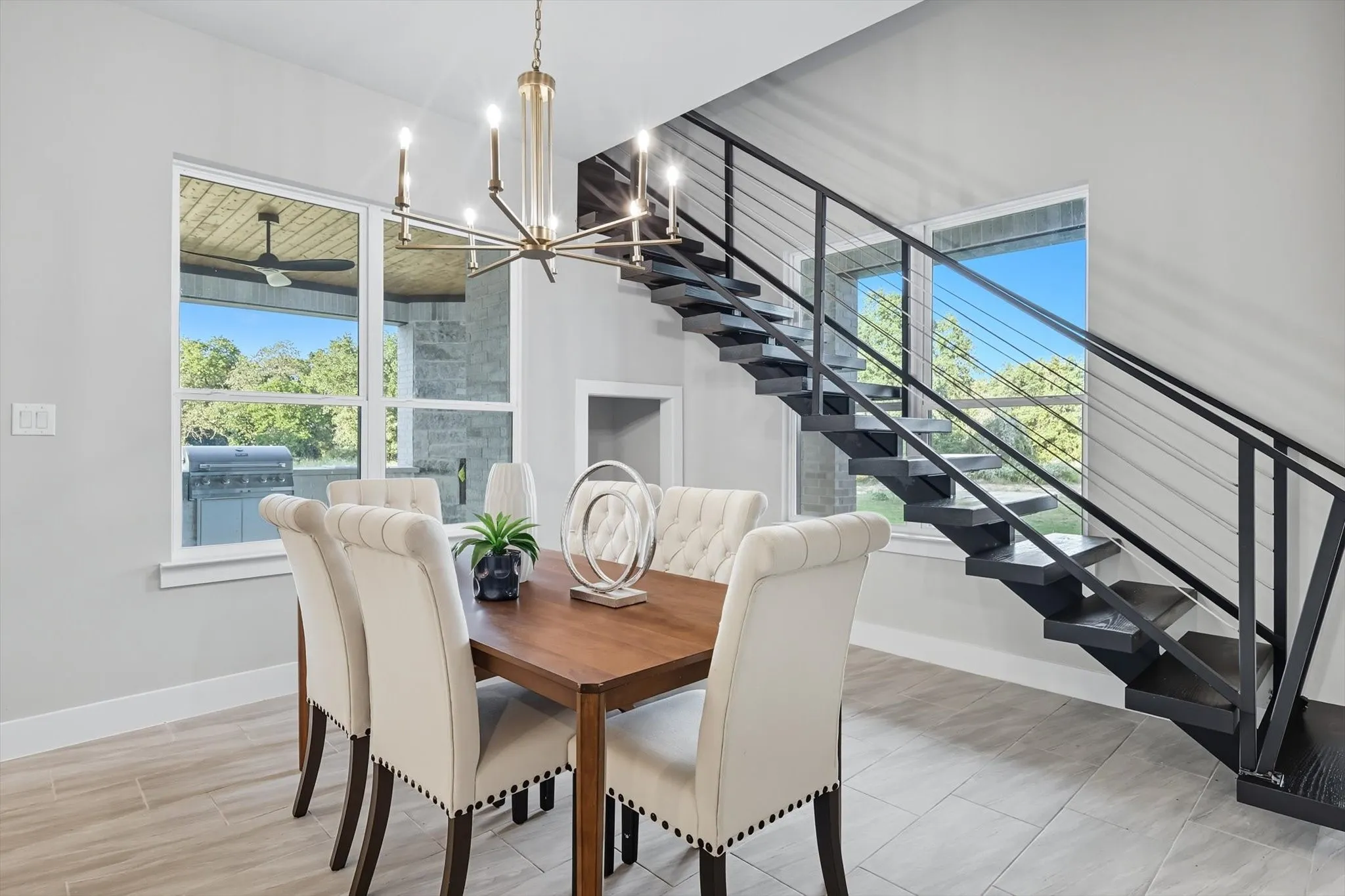 Dining space with plenty of natural light, a chandelier, and stairs