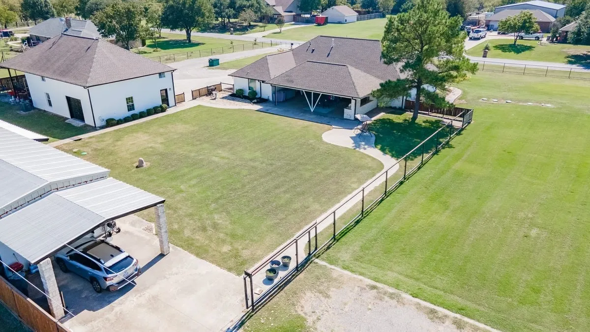 Large grass area between the Main house, detached garage with bonus space above garage and Guest House.