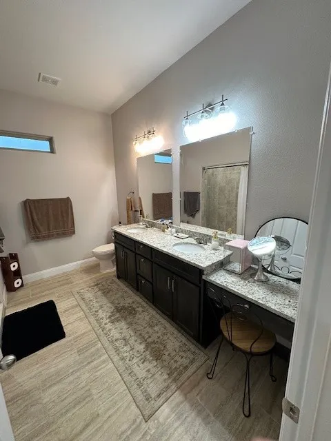 Bathroom featuring double vanity and curtained shower