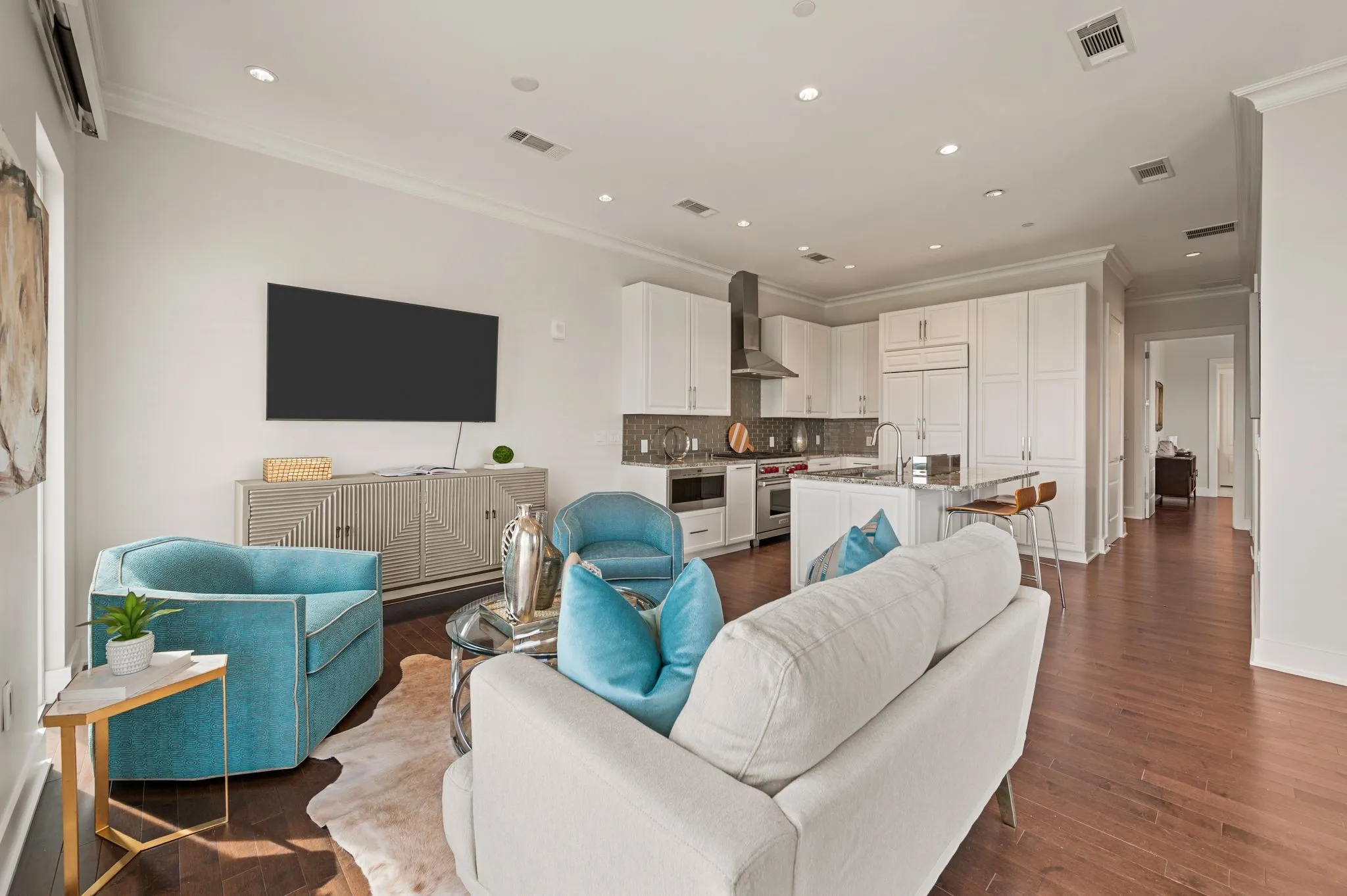 Living room featuring ornamental molding, dark wood-style floors, and recessed lighting