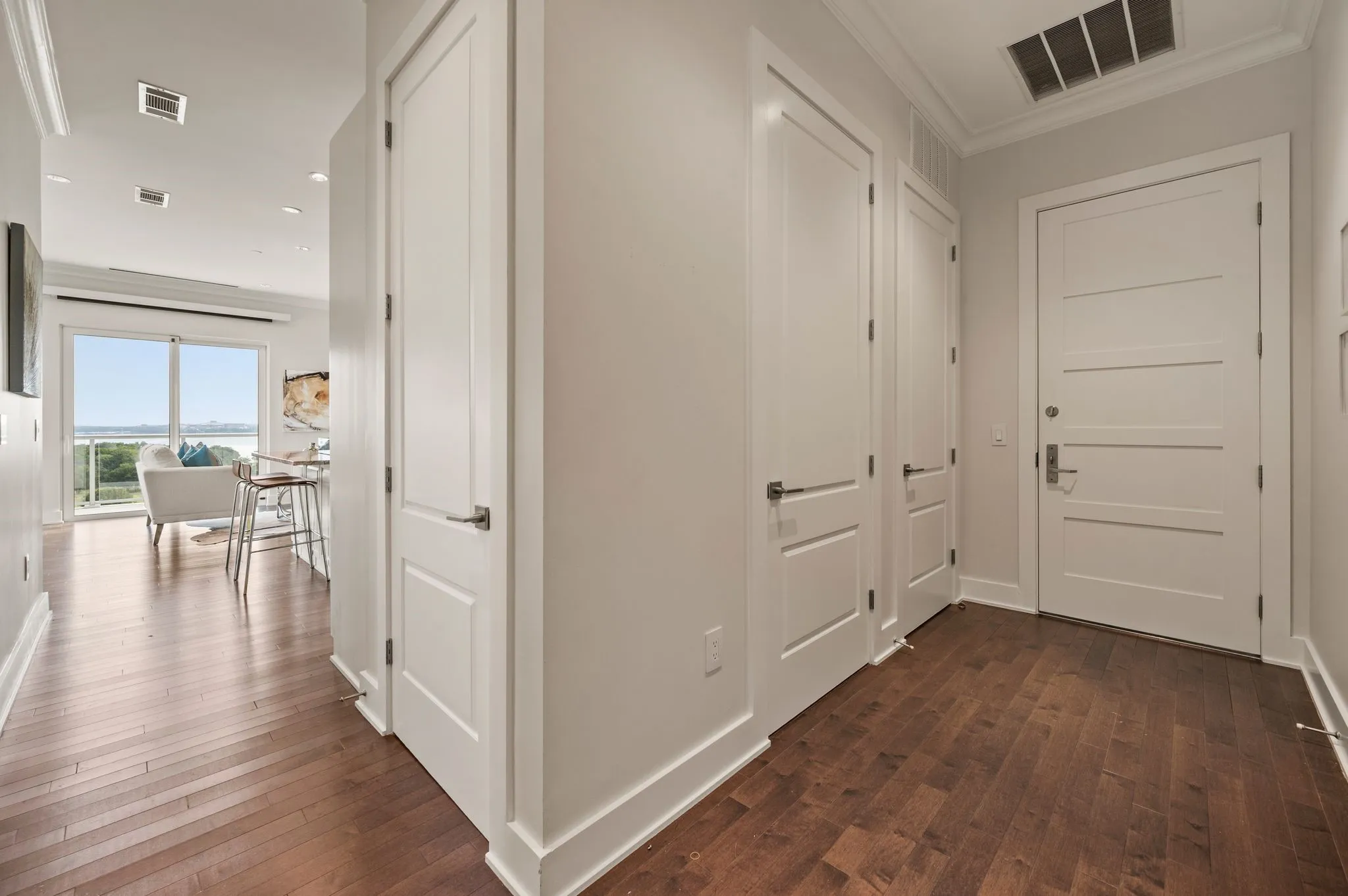 Corridor with crown molding, dark wood-type flooring, and recessed lighting