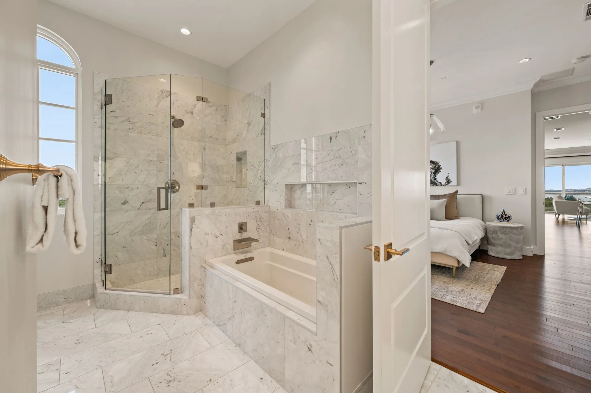 Ensuite bathroom featuring a marble finish shower, a garden tub, and recessed lighting