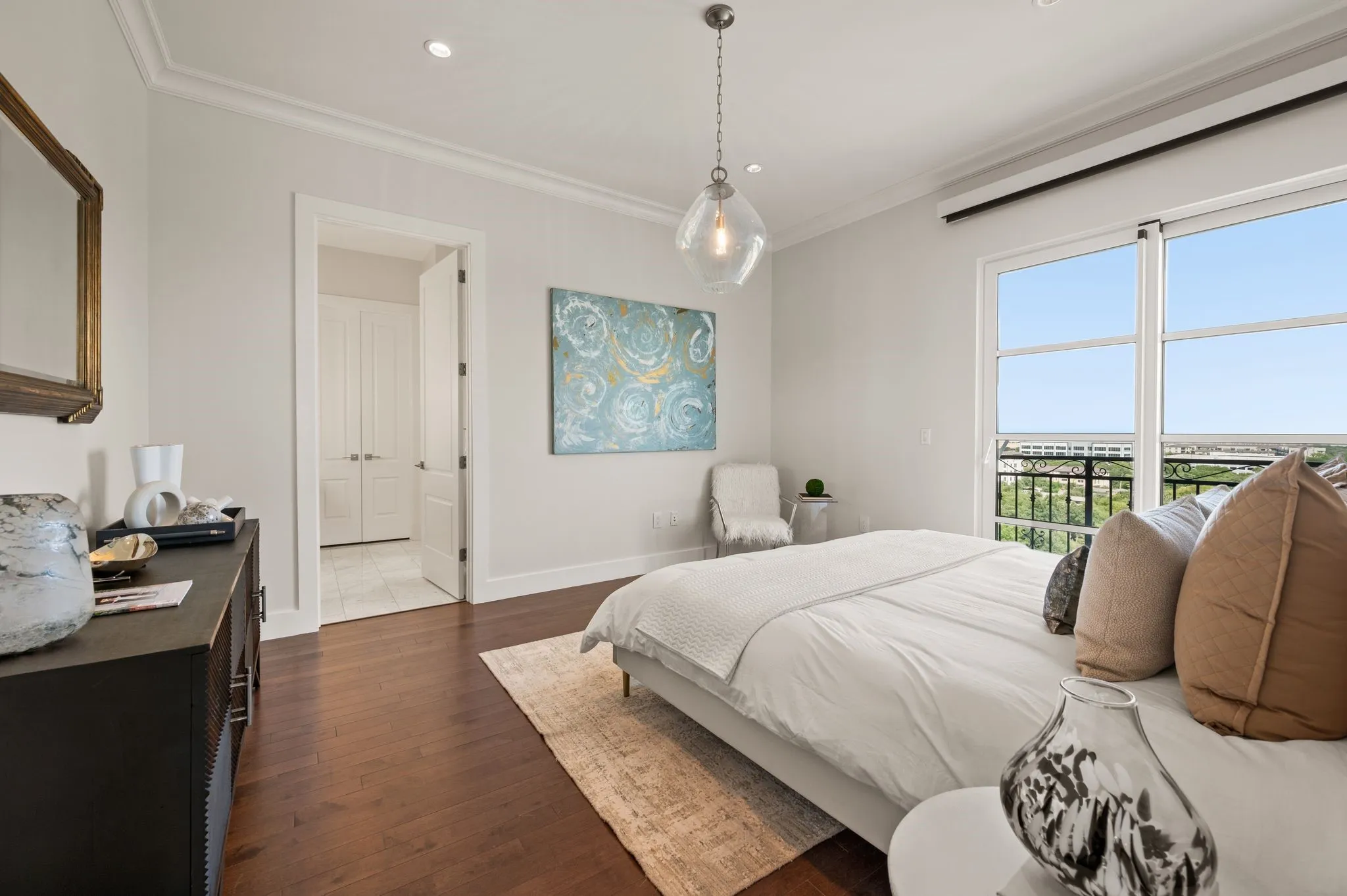 Bedroom with ornamental molding, dark wood finished floors, recessed lighting, and access to exterior