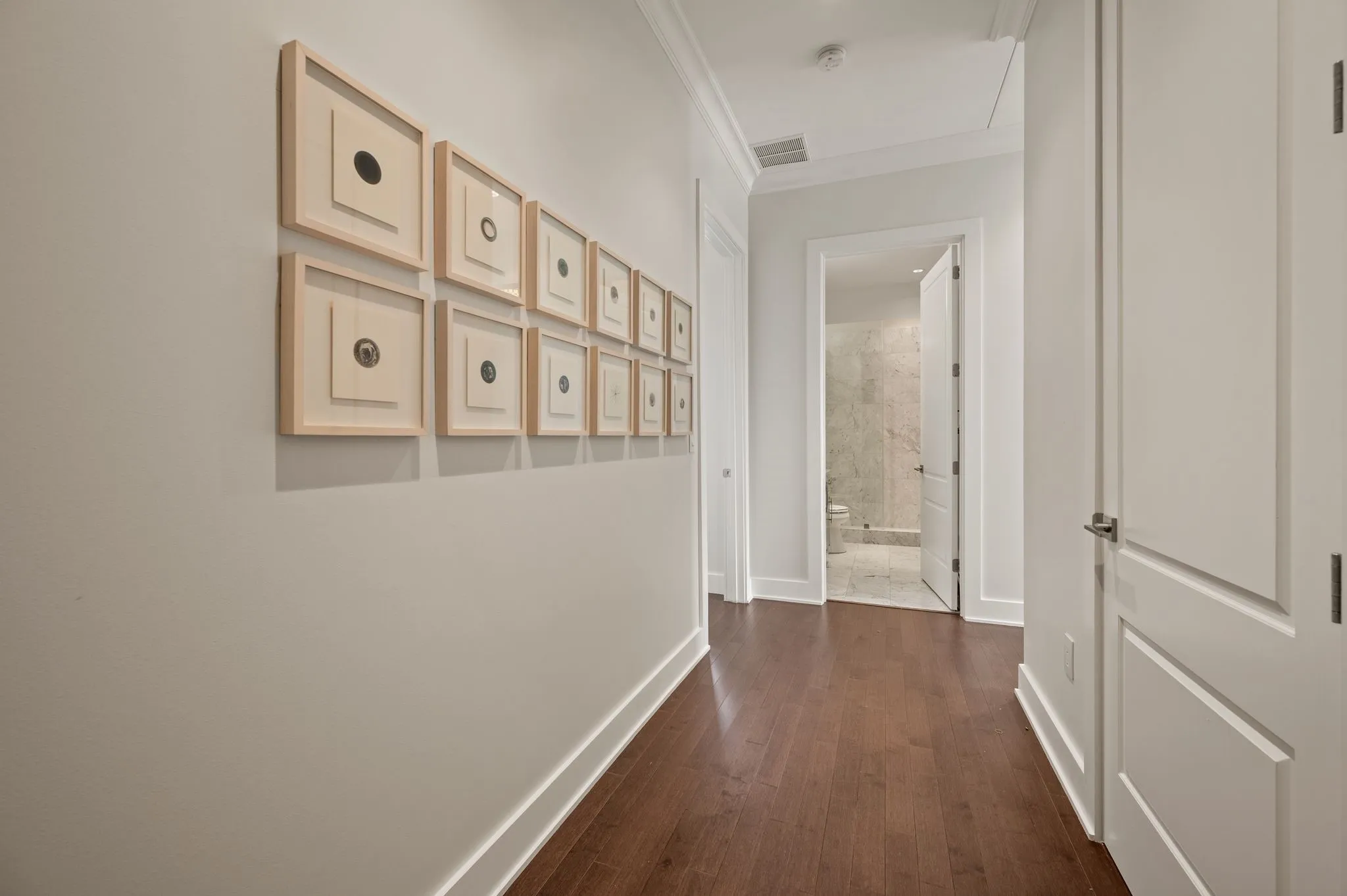 Hallway with ornamental molding and dark wood finished floors