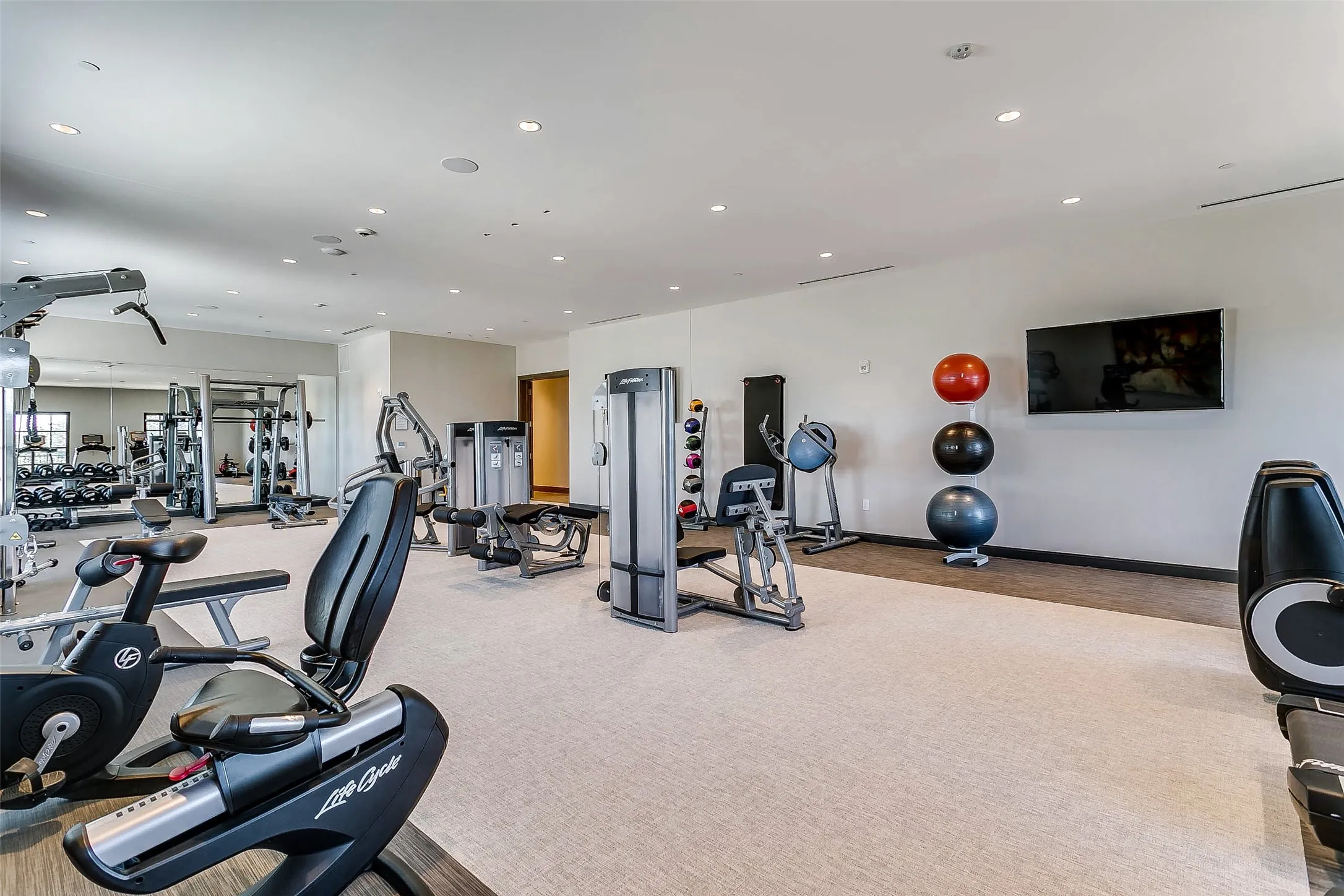 Full gym with equipment and locker rooms and baths and facilities