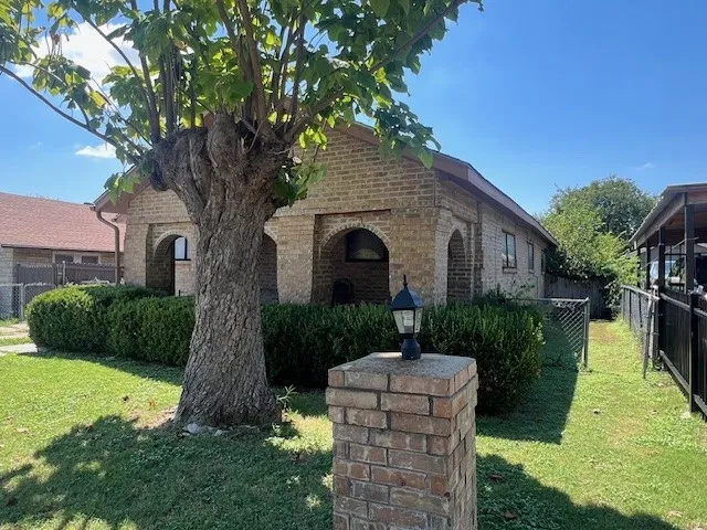 View of front facade featuring brick siding