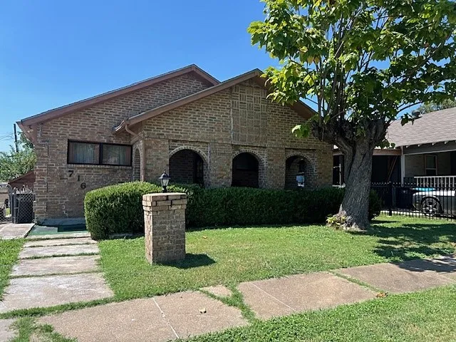 View of front facade featuring brick siding