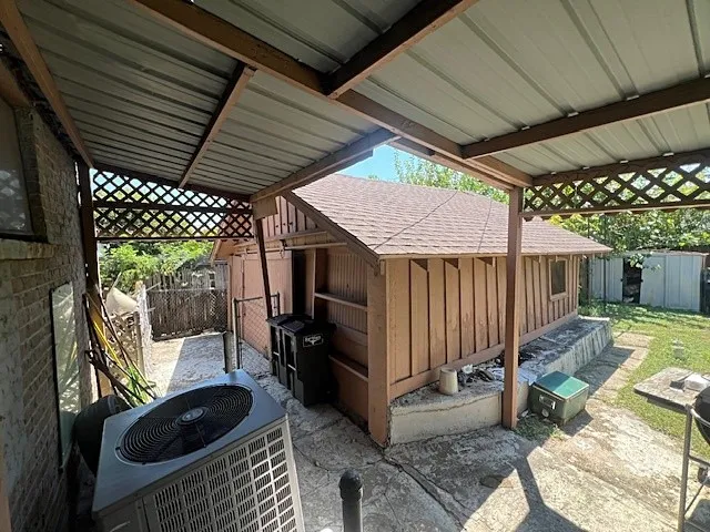 View of patio with a storage unit