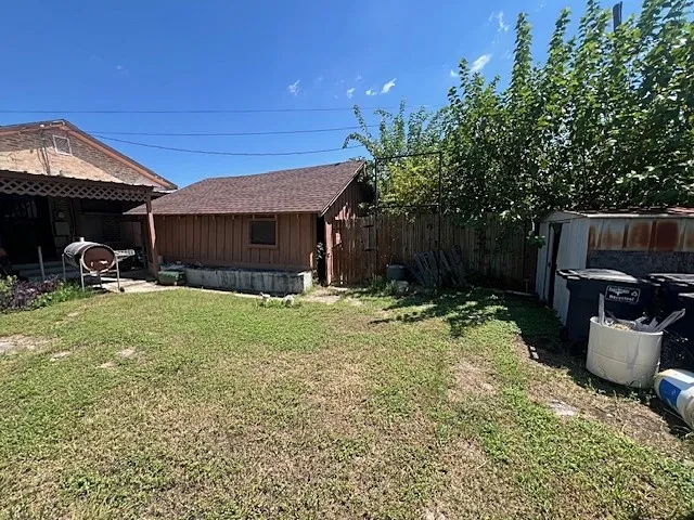 View of yard with a shed with covered patio