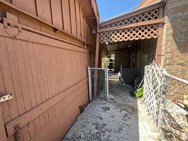 View of side of home with a patio area and a cooling unit