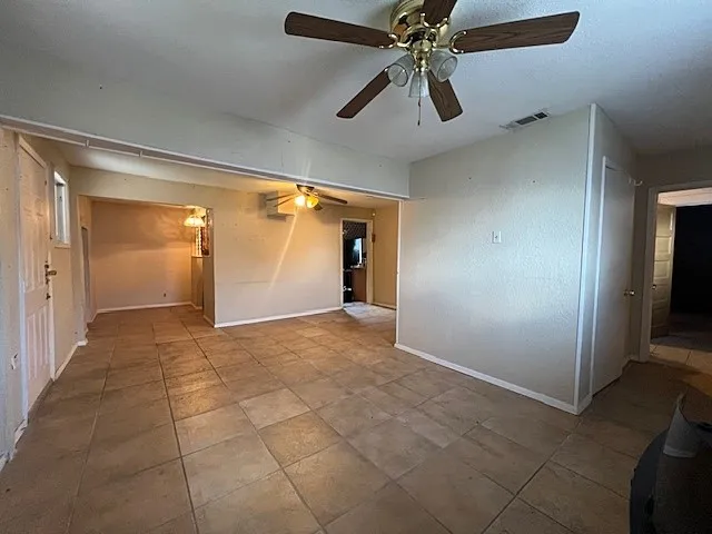 Family room with a ceiling fan and baseboards