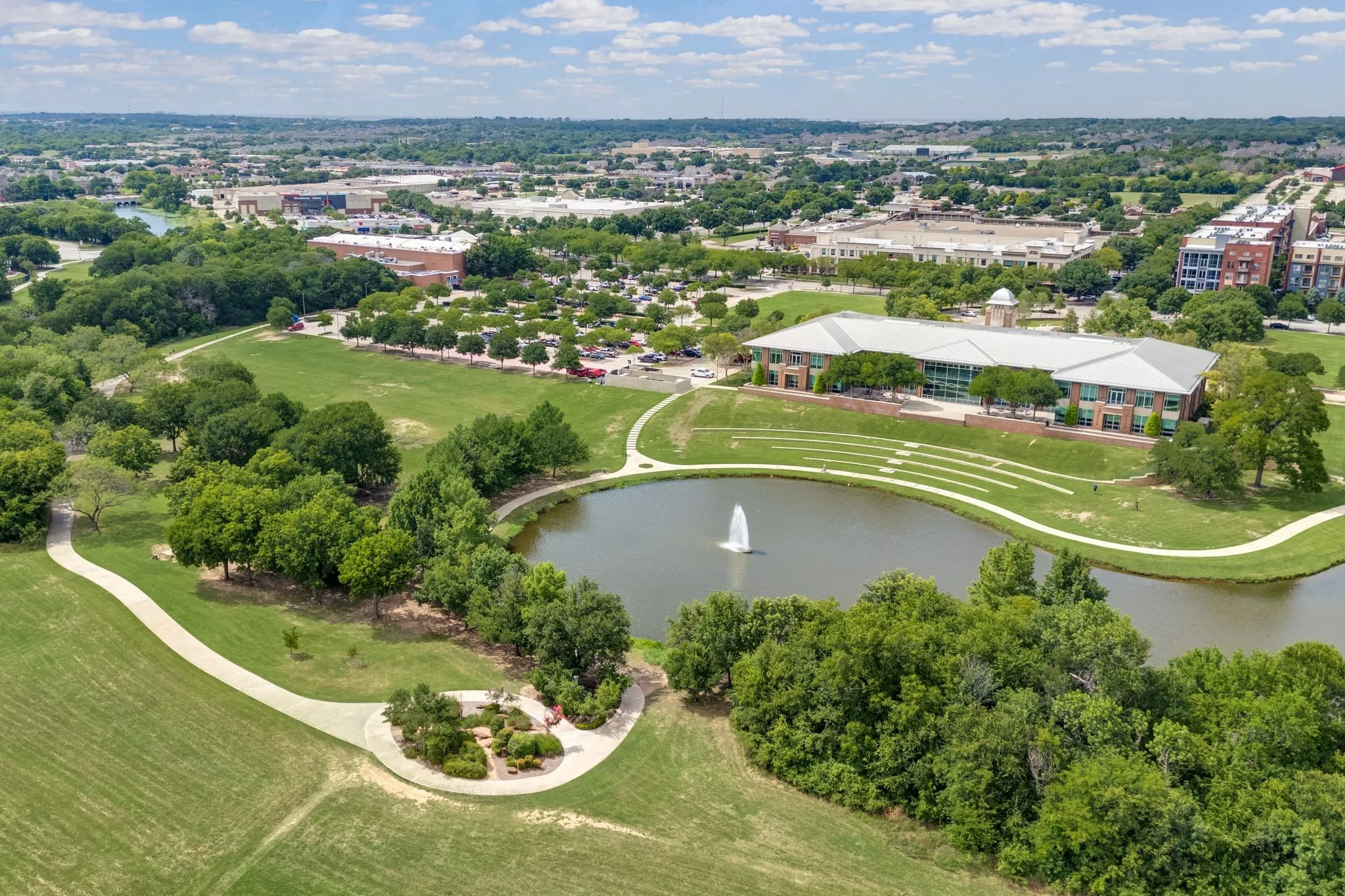 Bird's eye view of a nearby body of water and a tree filled landscape