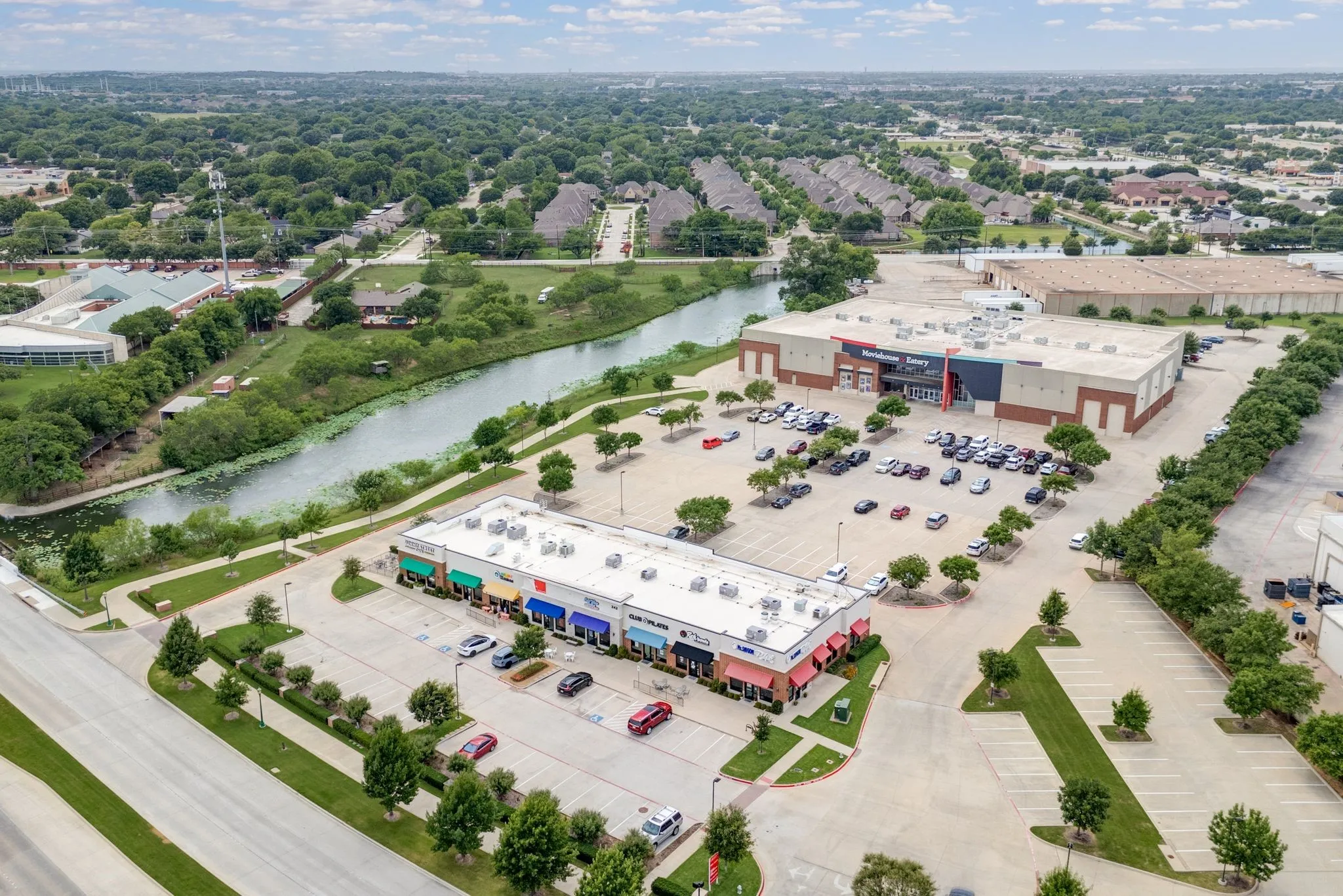 Bird's eye view of a commercial area and a large body of water