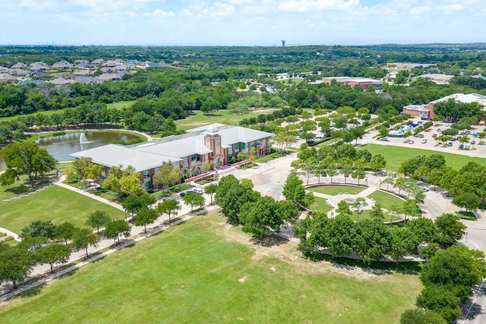 Drone / aerial view of a tree filled landscape and a large body of water