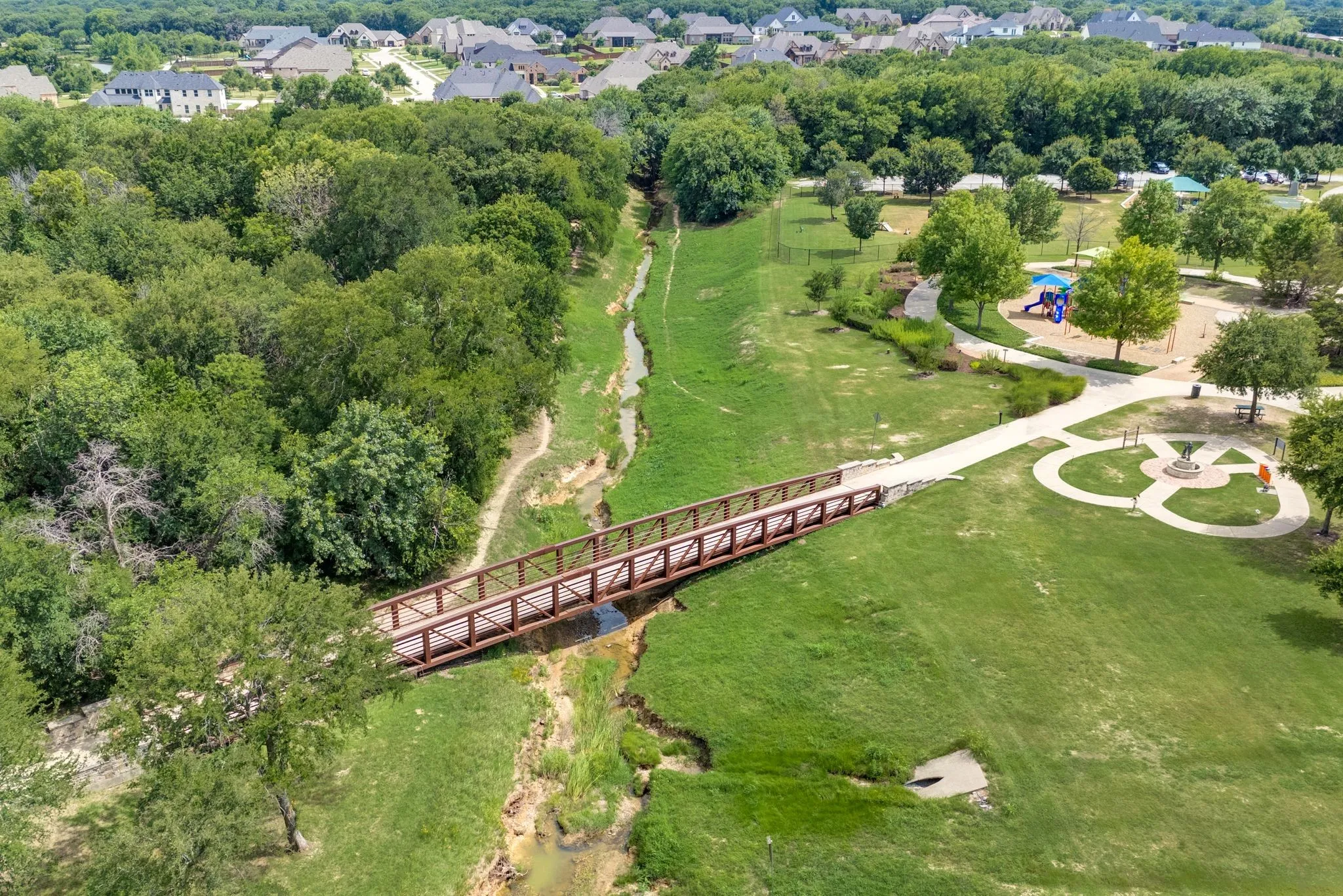 Aerial view of a community park and a tree filled landscape