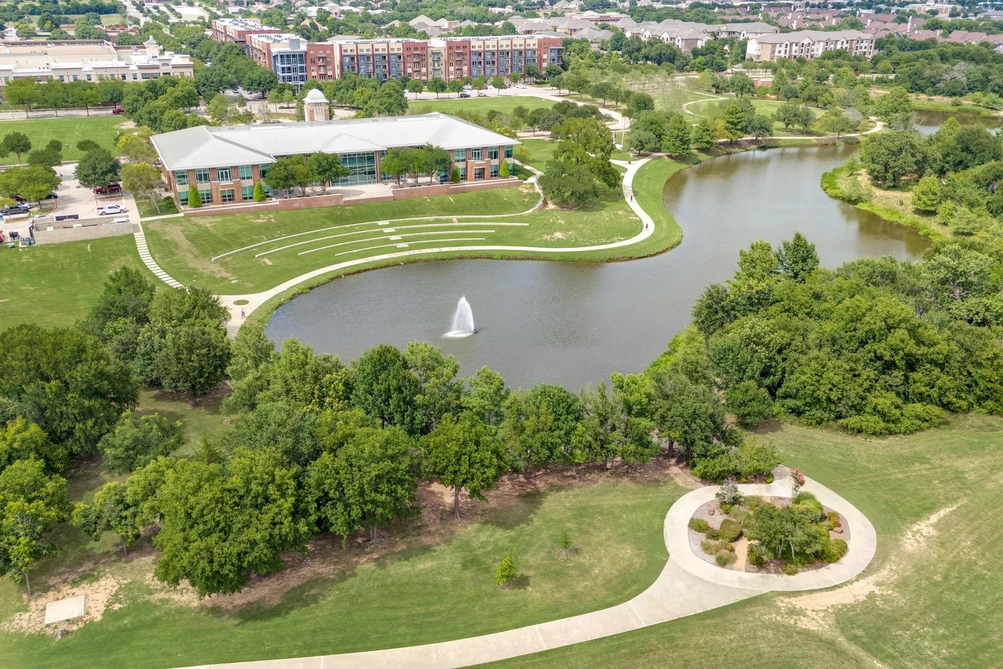View of property location featuring a nearby body of water and a tree filled landscape