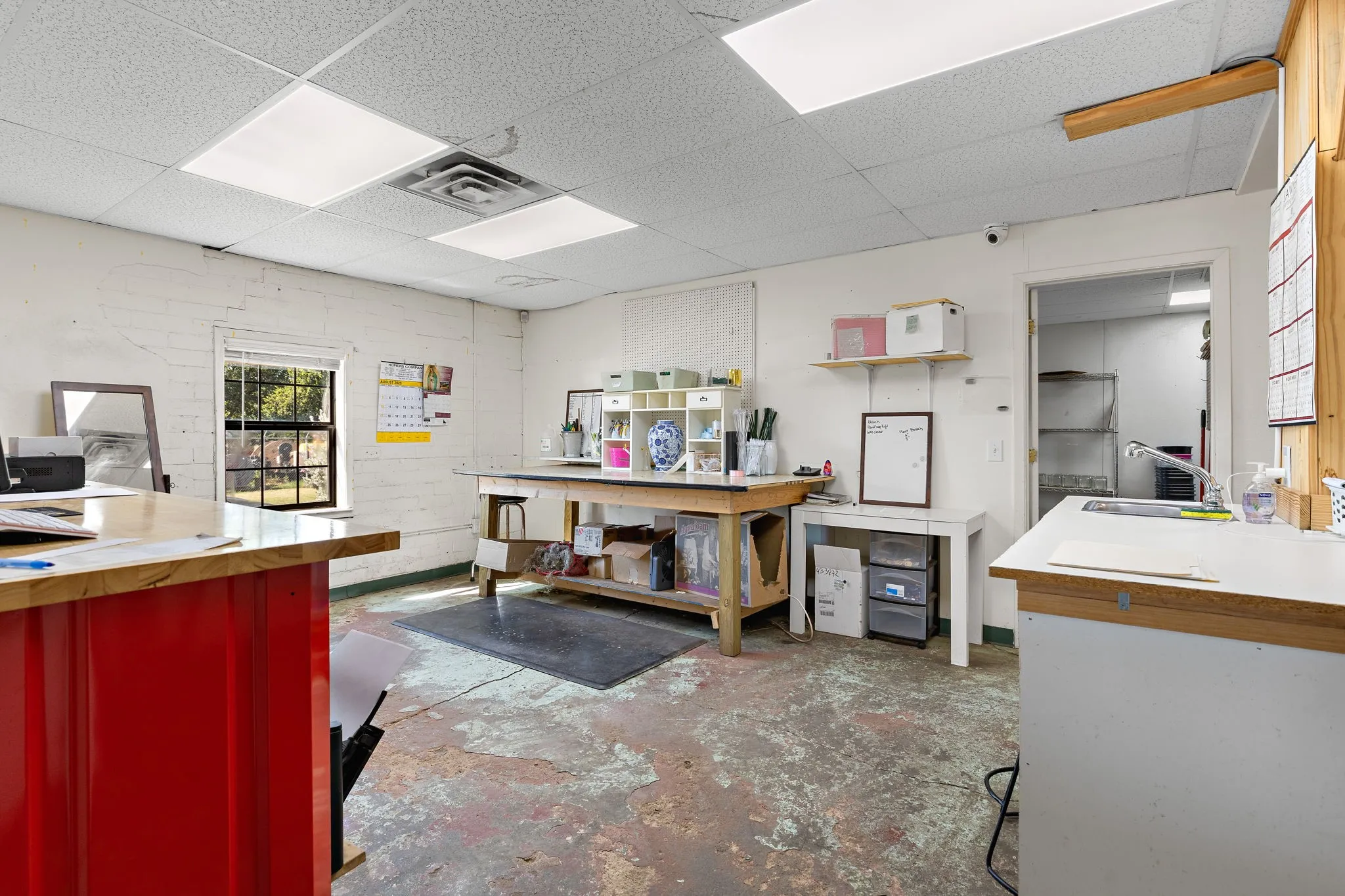 Misc room with concrete flooring and a paneled ceiling