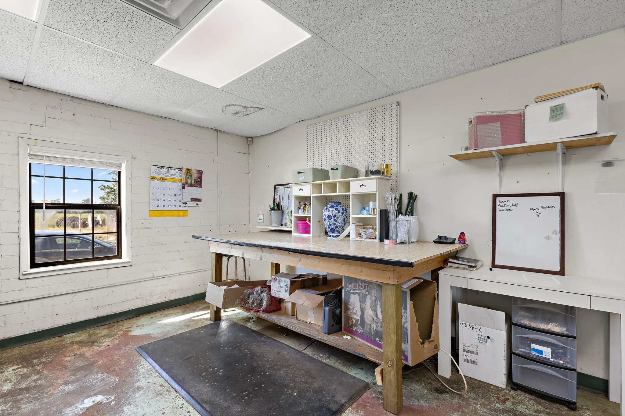 Miscellaneous room featuring concrete floors and a drop ceiling