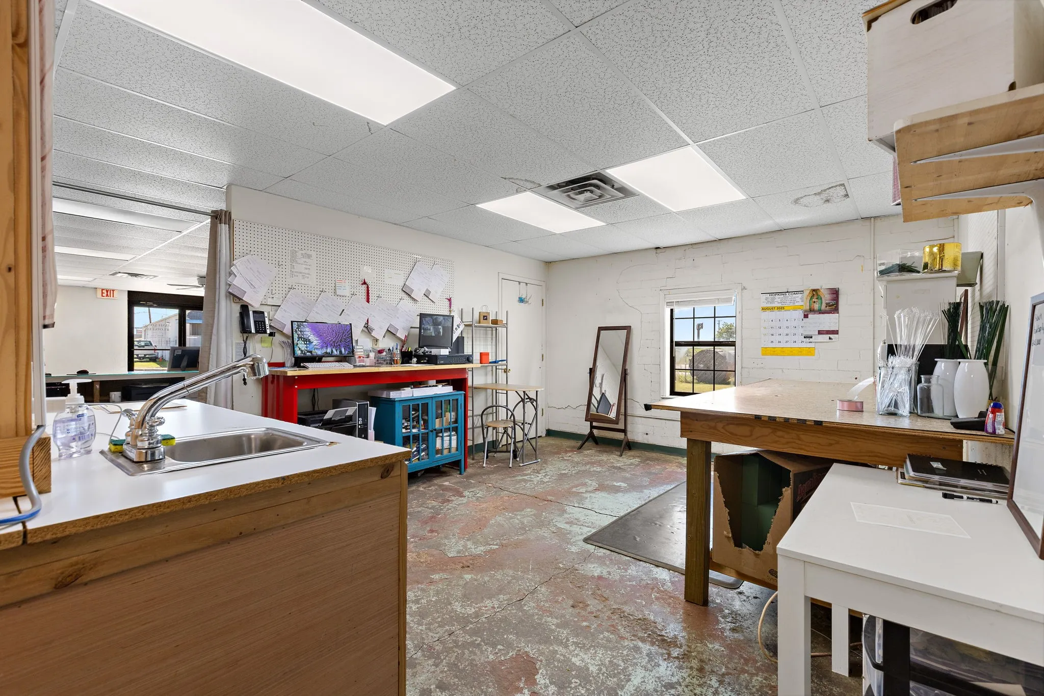Kitchen with a drop ceiling, concrete floors, and light countertops