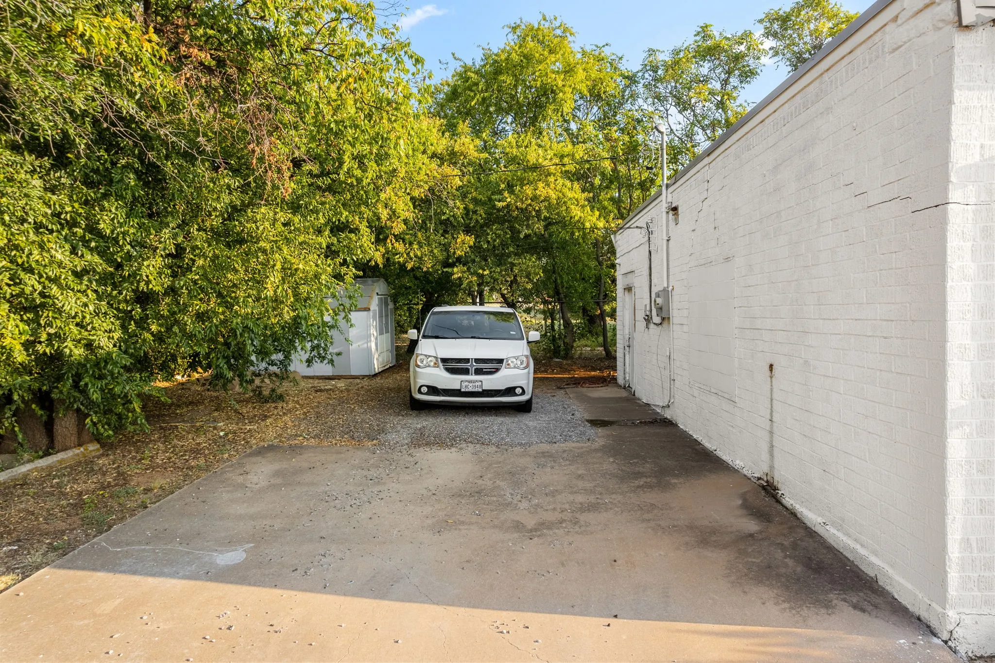View of parking featuring a storage unit