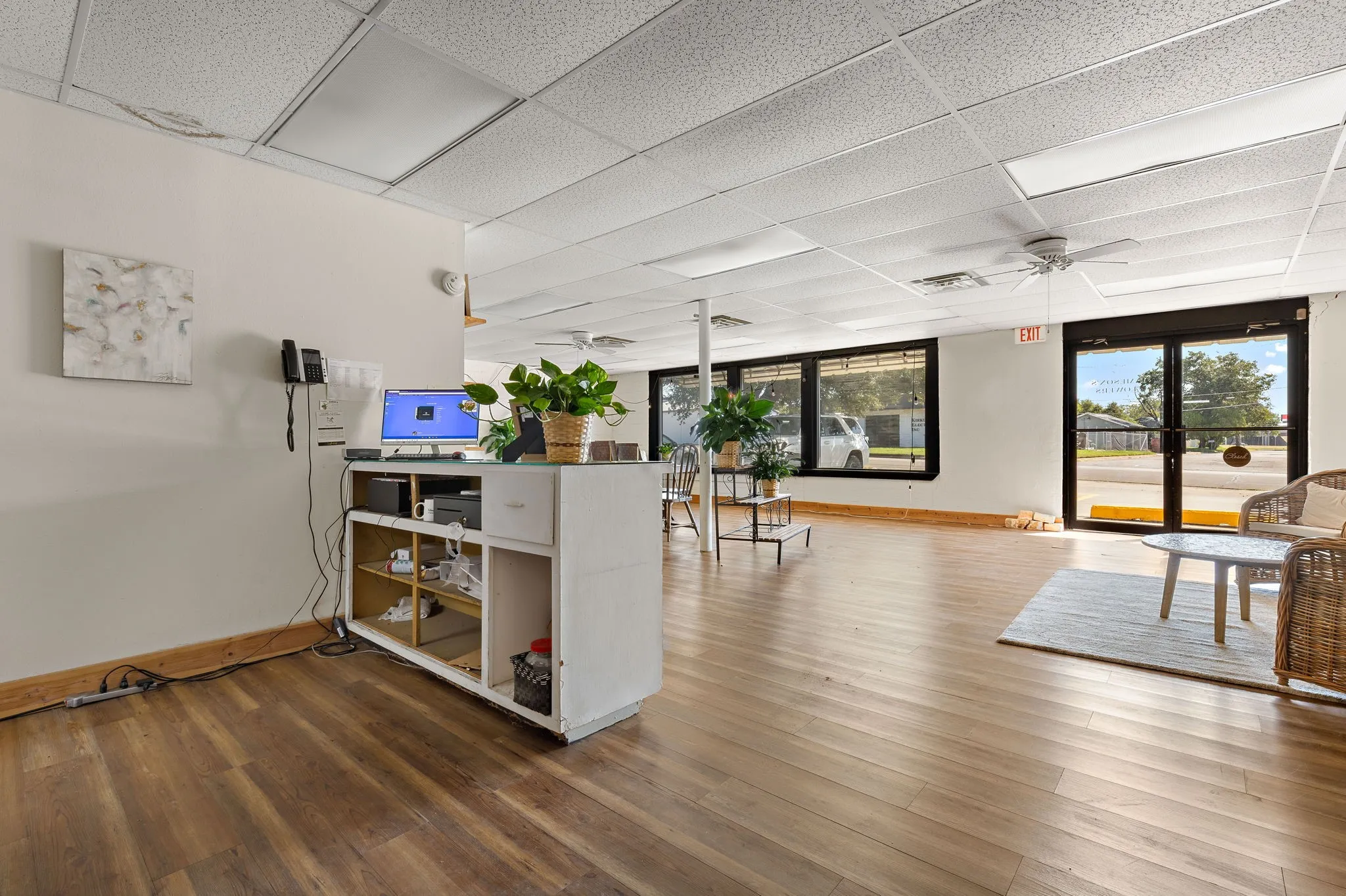 Office featuring ceiling fan, a paneled ceiling, and light wood-type flooring