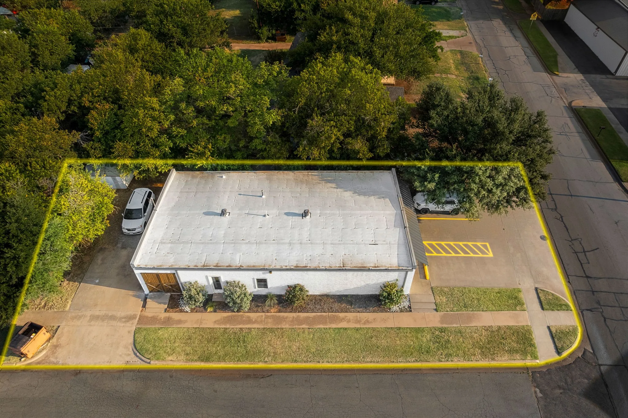 Aerial view of property and surrounding area with property parcel outlined