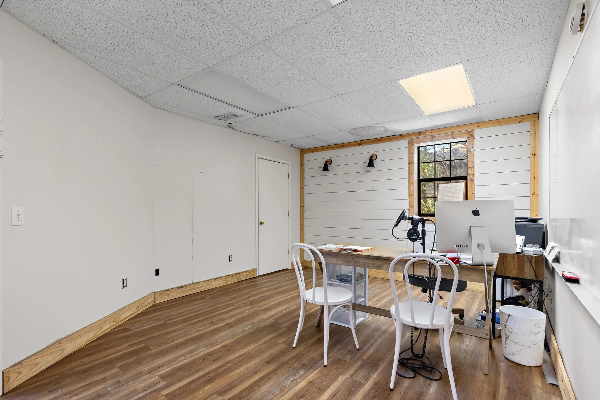 Office featuring wood finished floors and a drop ceiling