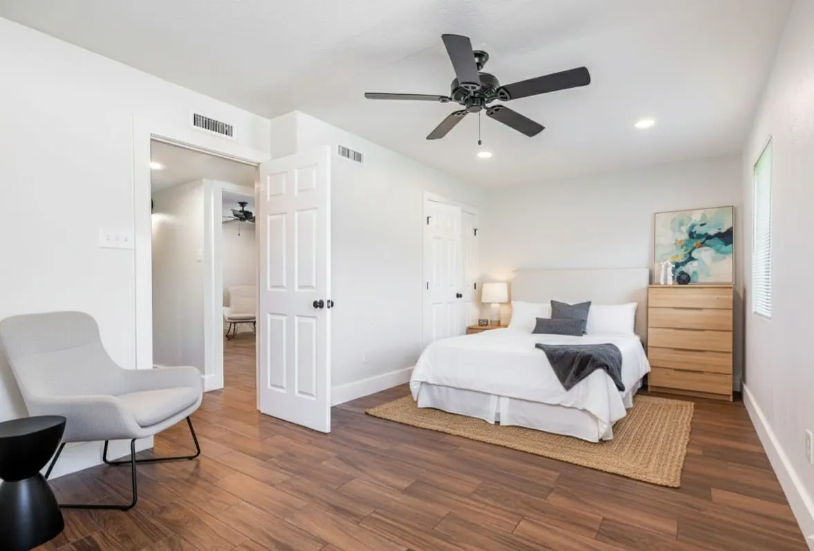 Bedroom with wood finished floors, ceiling fan, and recessed lighting