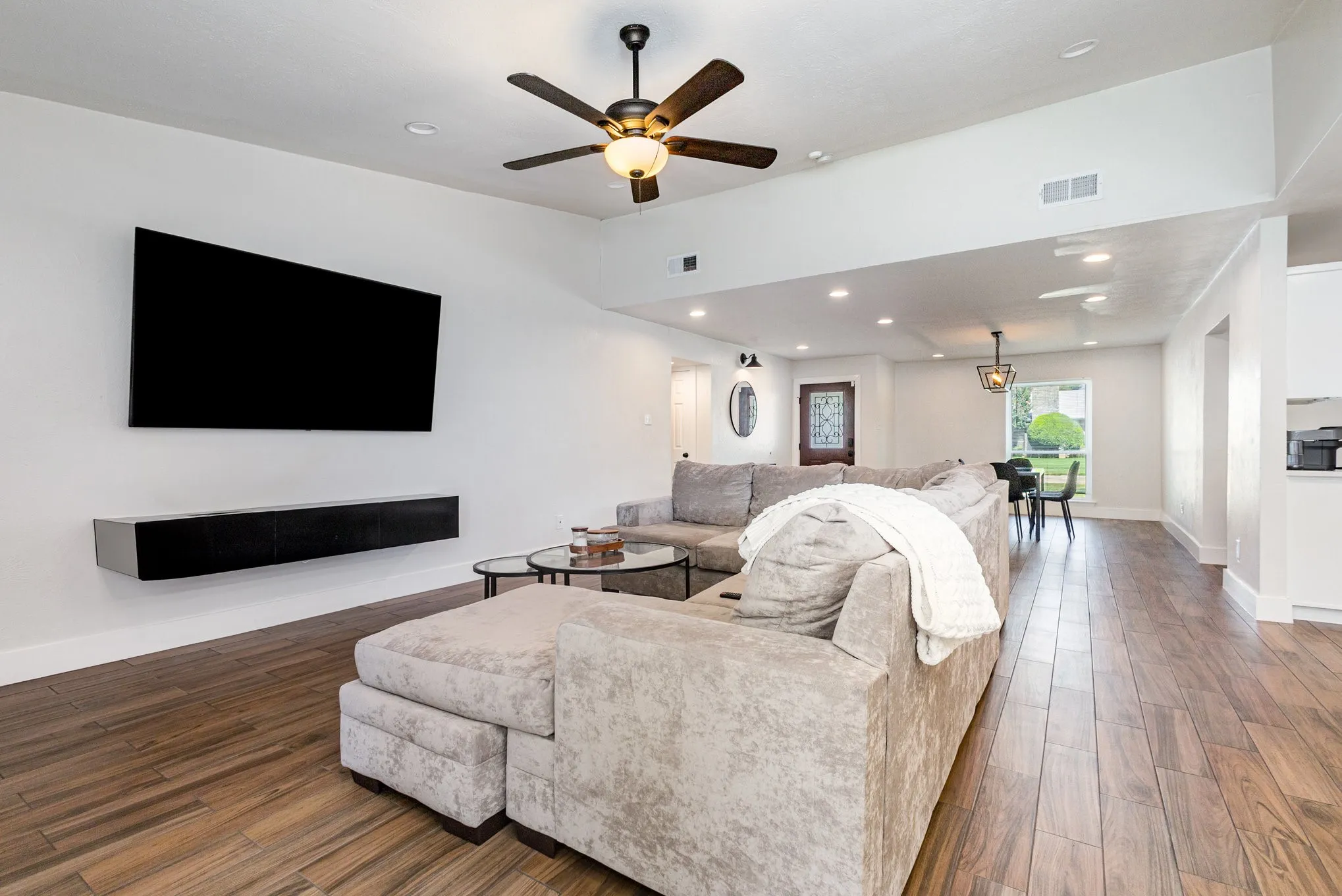Living room featuring wood finished floors, recessed lighting, and ceiling fan