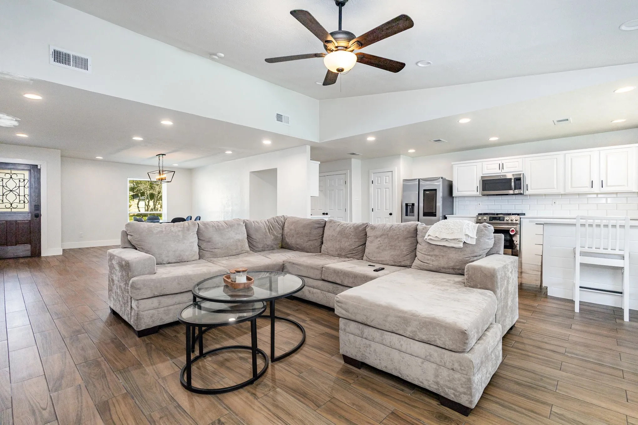 Living area featuring recessed lighting, wood finished floors, vaulted ceiling, and a ceiling fan