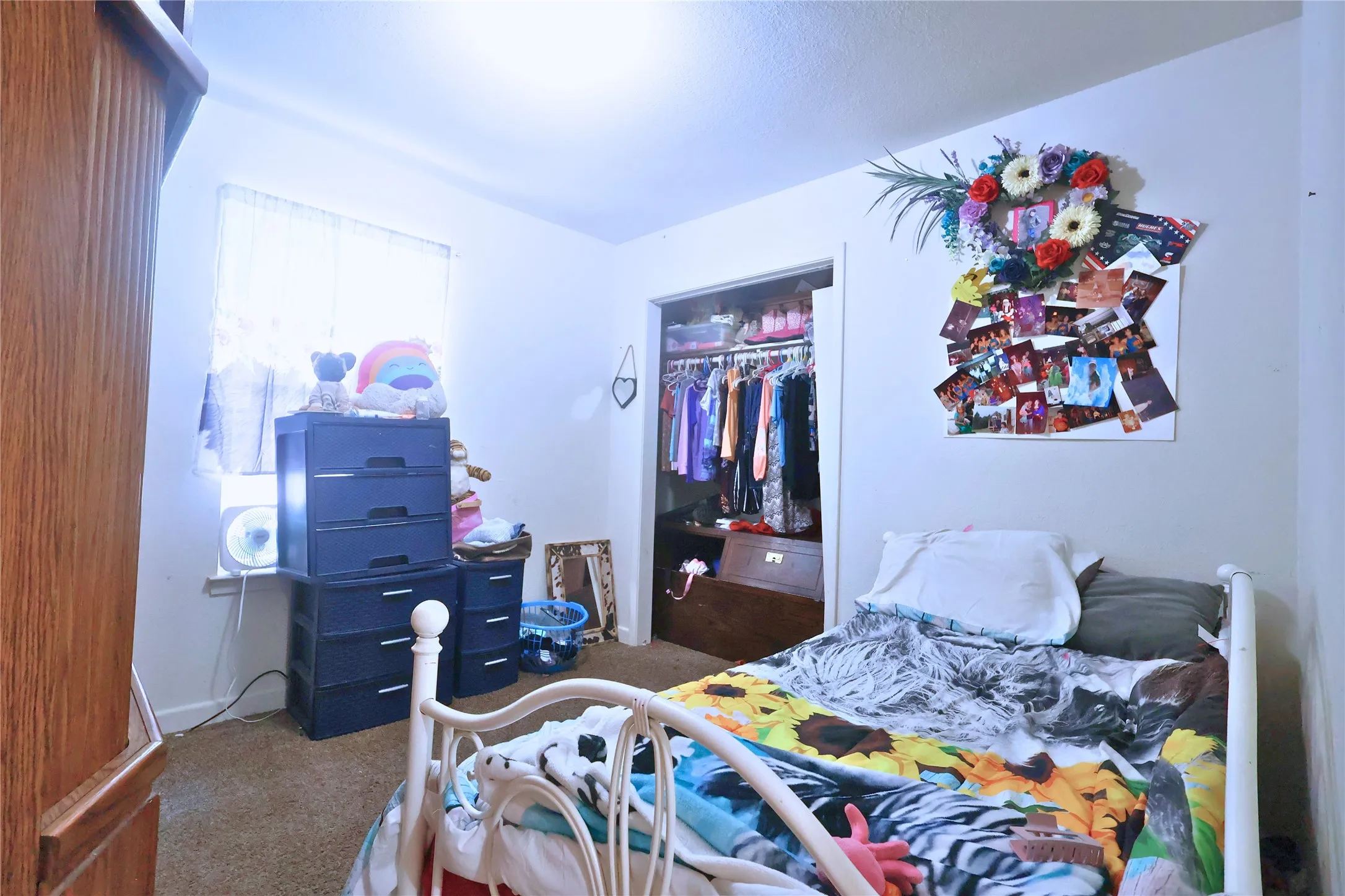 Carpeted bedroom featuring a closet