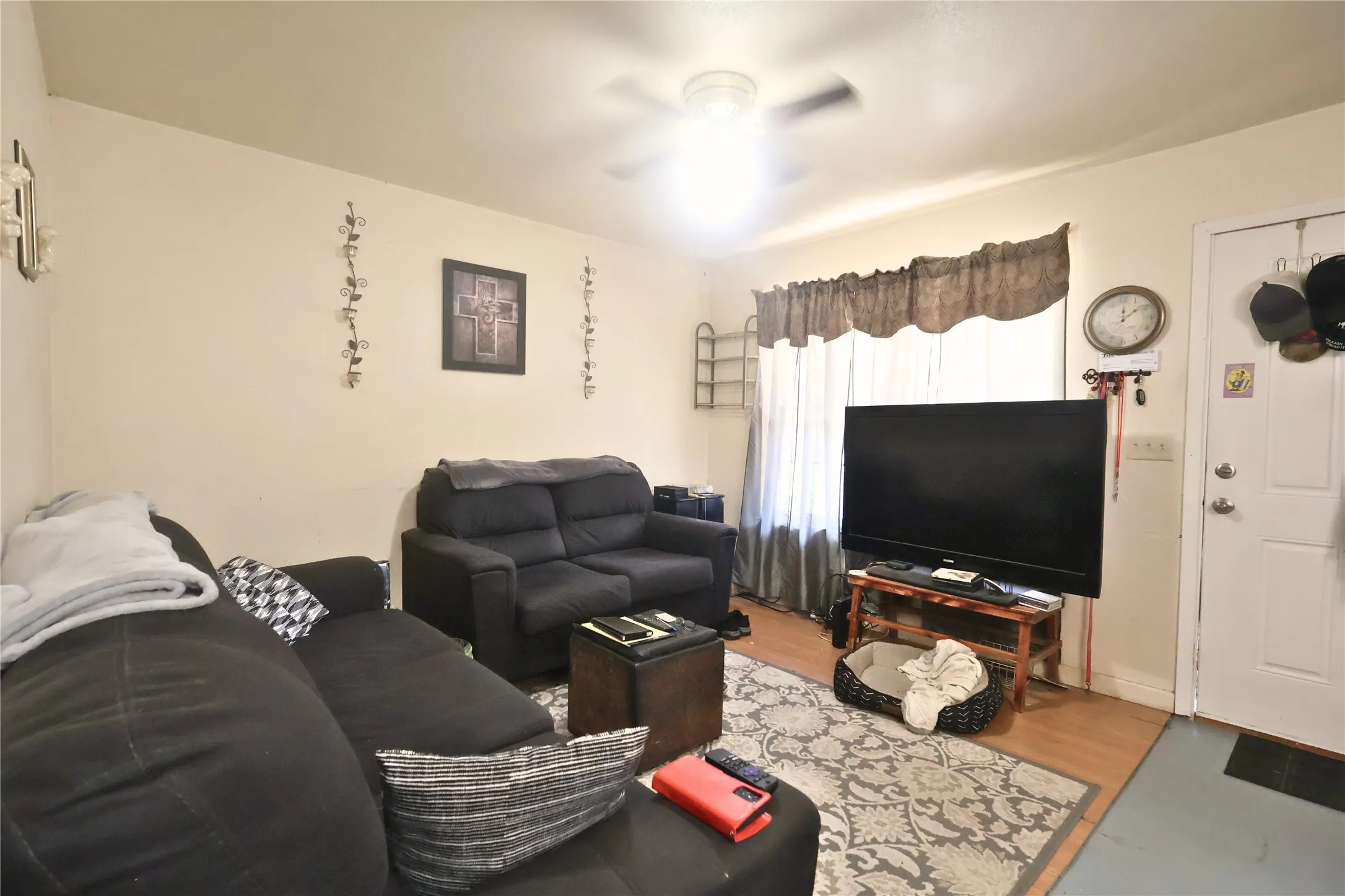 Living area with wood finished floors and a ceiling fan