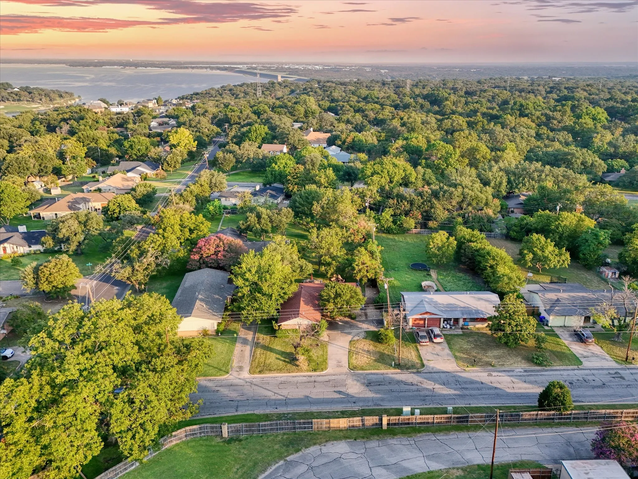 Aerial view at dusk of a water view and a residential view