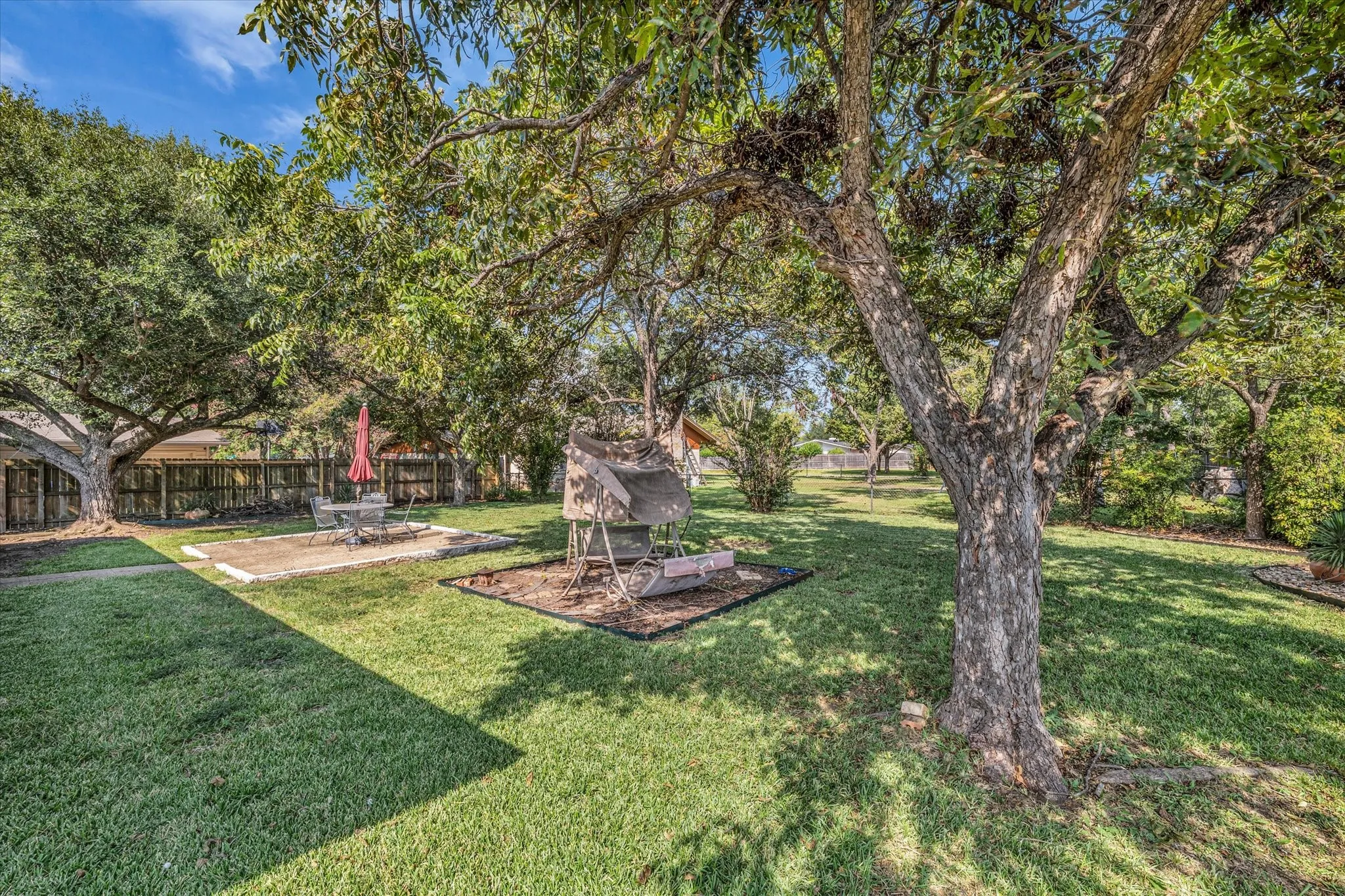 View of yard with a patio and view of wooded area