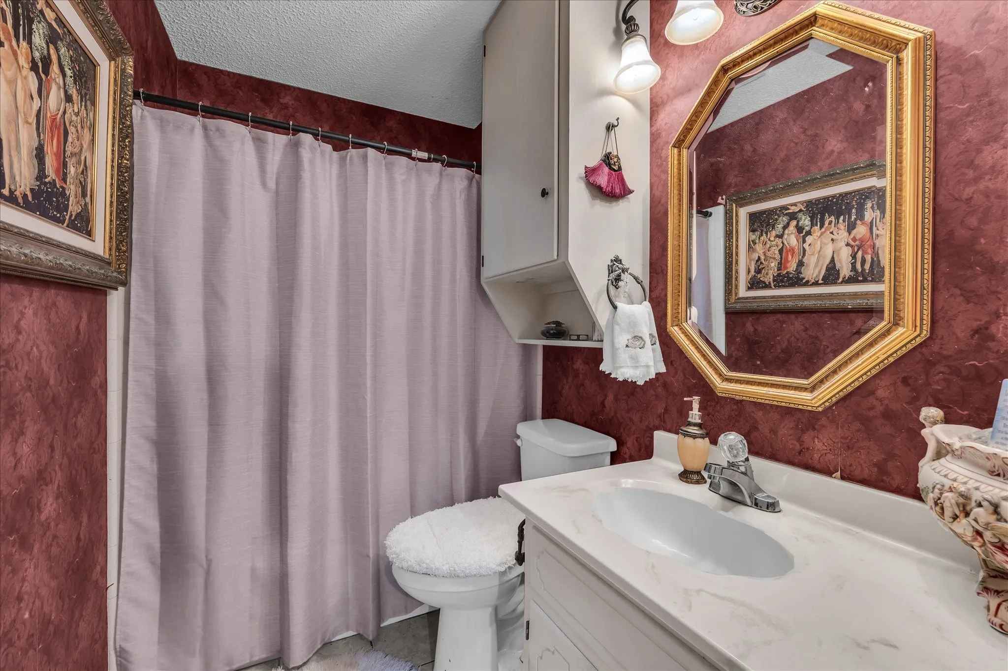 Full bath with a textured ceiling, vanity, and curtained shower