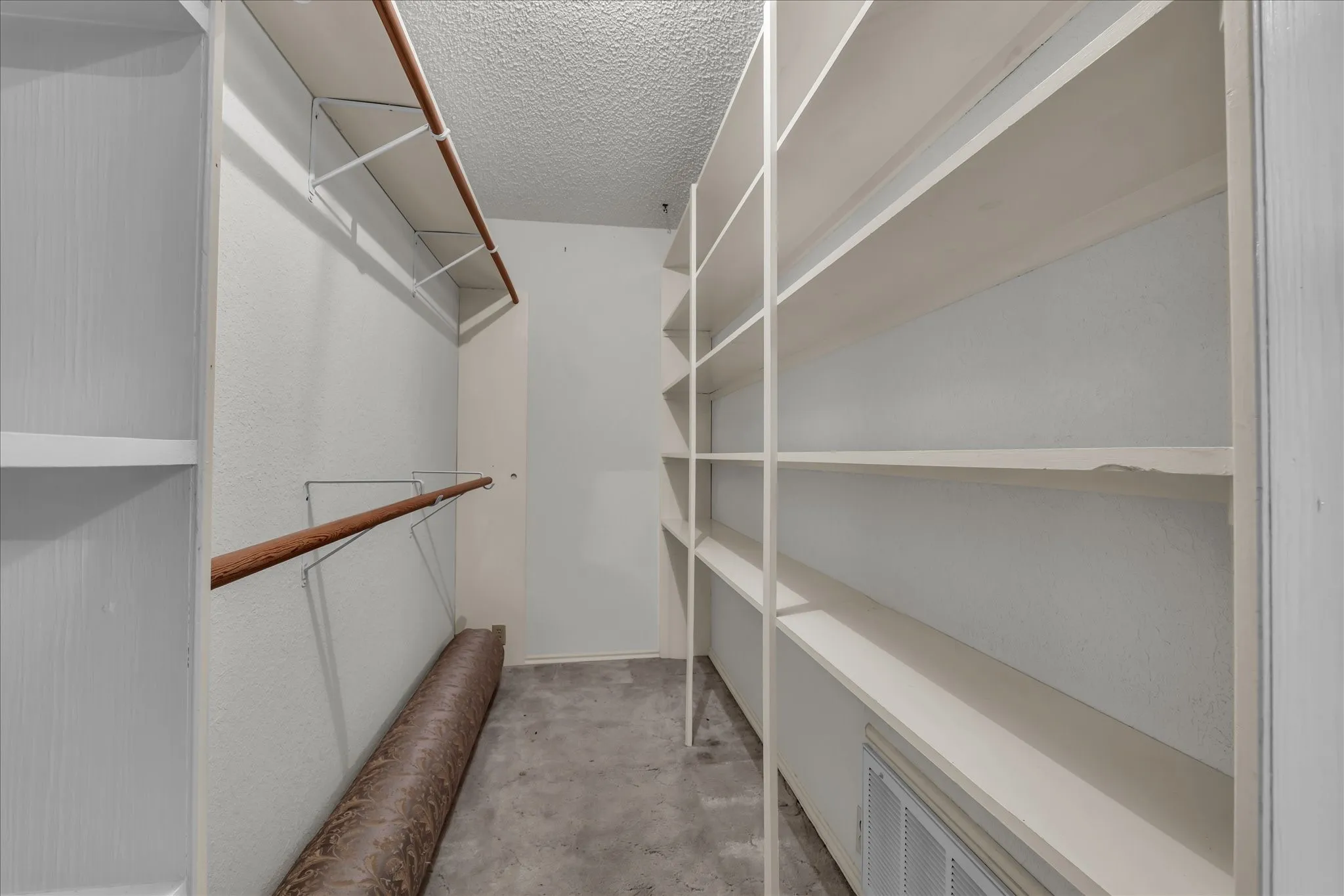 Walk in closet featuring light colored carpet