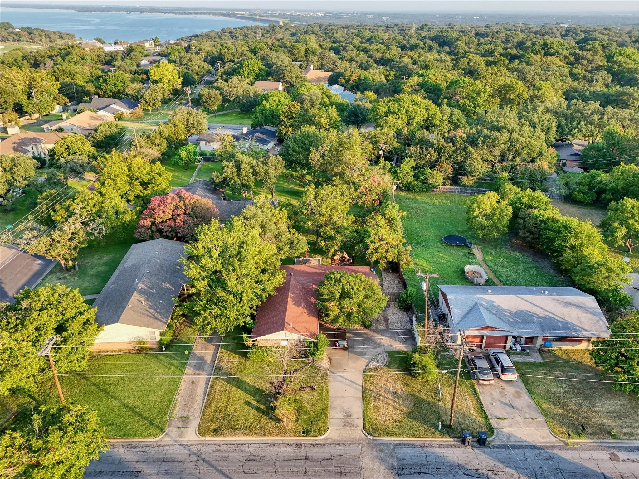 Aerial perspective of suburban area featuring a nearby body of water