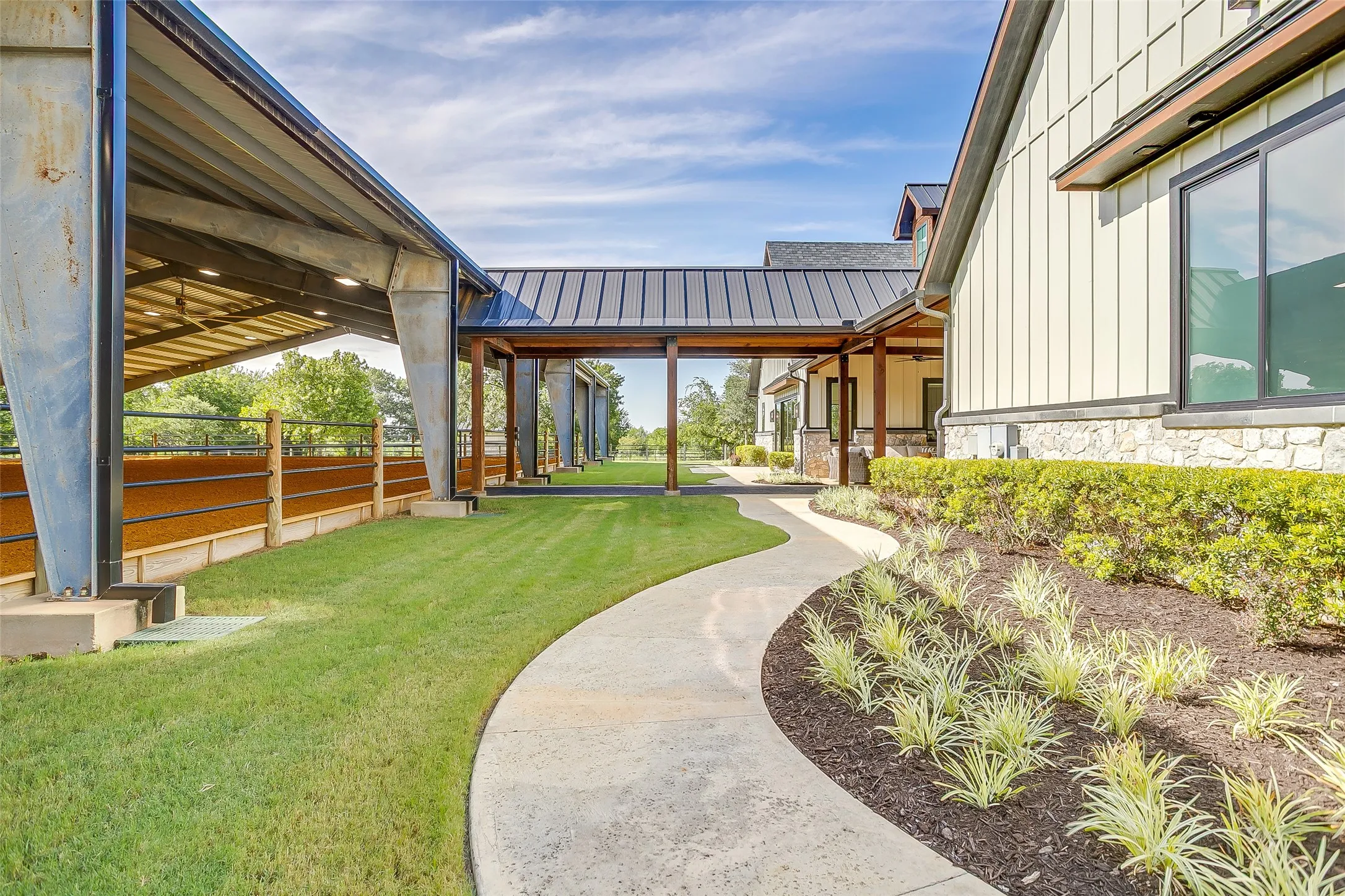 Covered walkway from arena to barn ensures dry, comfortable access between sessions in any weather.