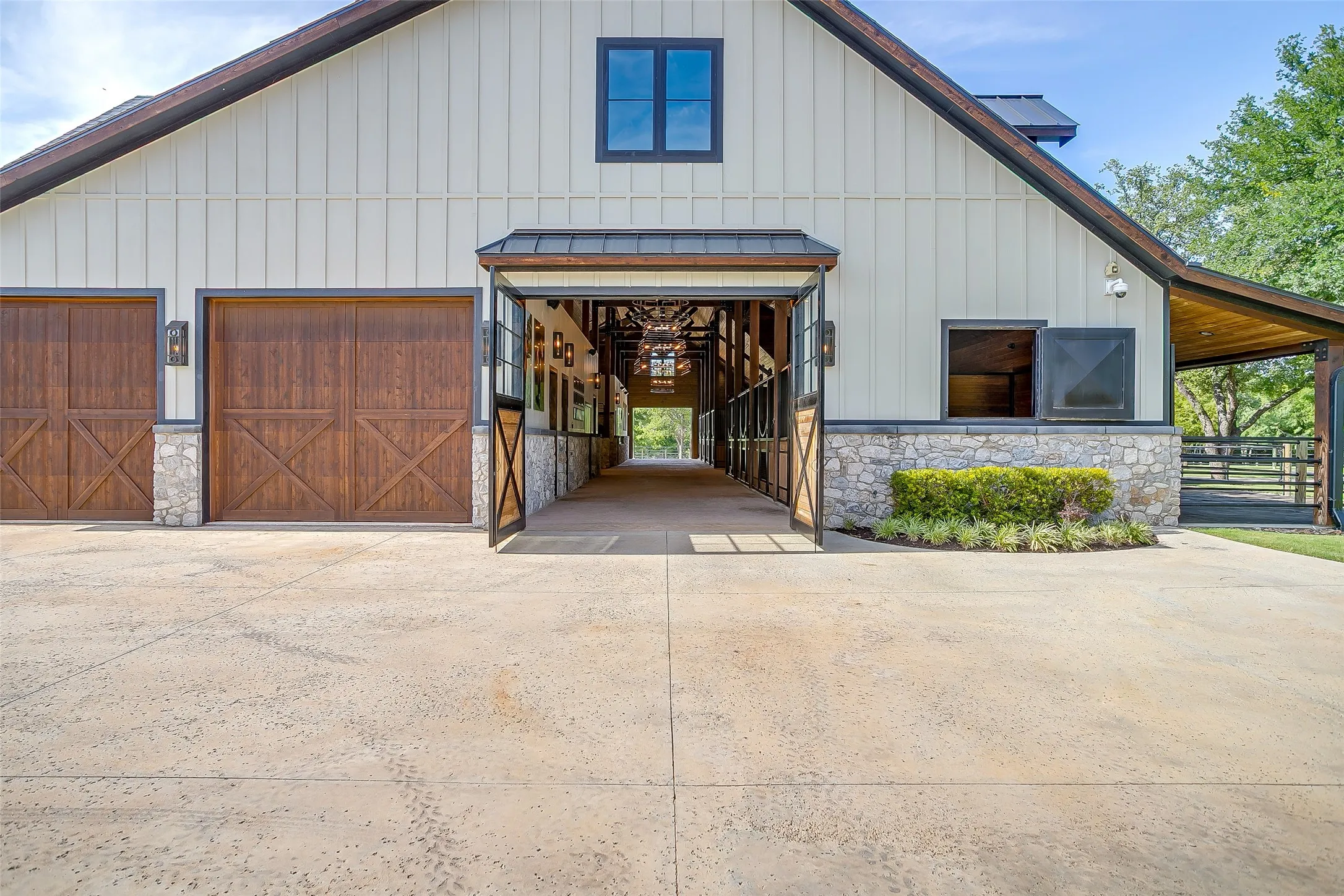 Feed room designed with a custom roll-up door, allowing trailers to back in for effortless unloading directly into the barn alley.