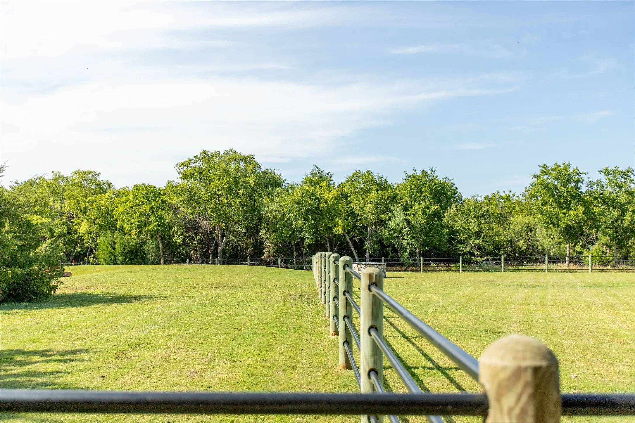 Pipe fencing runs along the driveway — showcasing
the detail and durability throughout.
