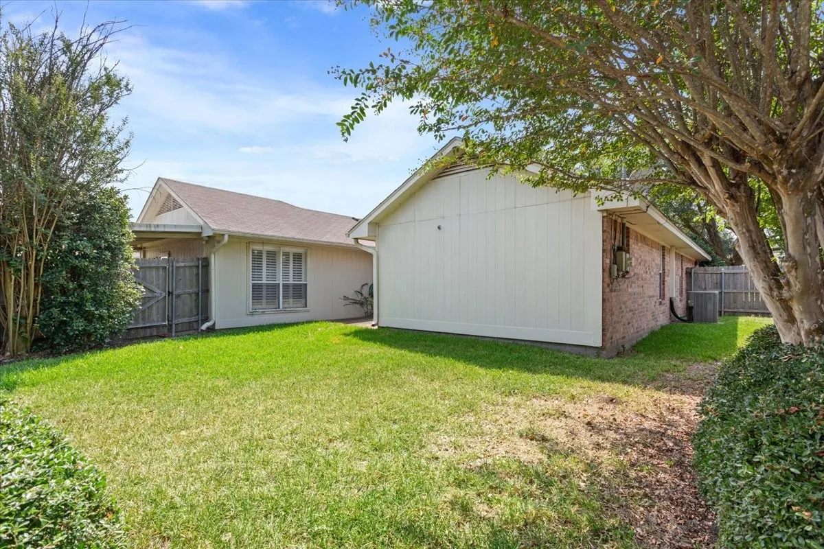 Rear view of property featuring brick siding