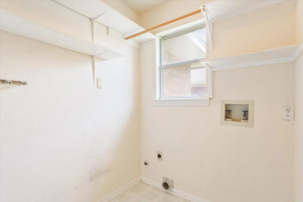 Laundry room with hookup for an electric dryer, washer hookup, gas dryer hookup, and tile patterned floors
