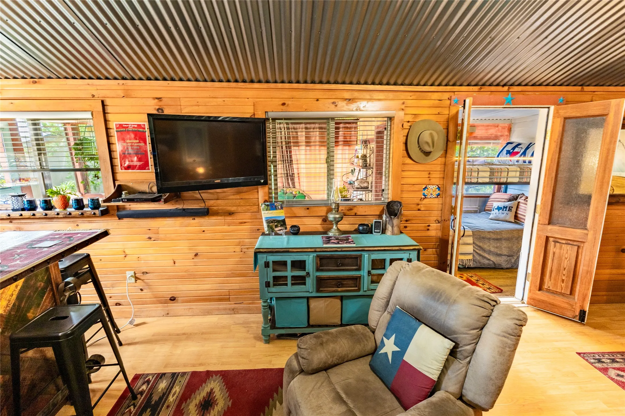 Convenient wall-mount tv; windows for natural light; doors to the bunk room can be closed.